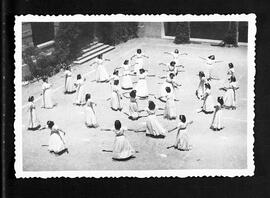Grup de dones ballant al pati de l'escola