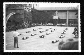 Alumnes homes fent exercicis de gimnàstica al pati