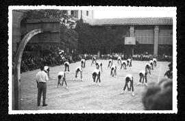 Alumnes homes fent exercicis de gimnàstica al pati